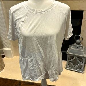 White Tshirt. ruffling on back.cut tag out when bought.Large-ish.Unsure brand